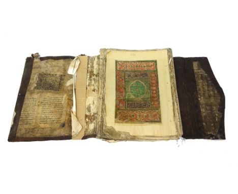 A large South East Asian Qur'an, two illuminated leaves, manuscript text with red-ruled borders and some illuminated decorati