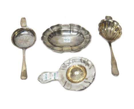 A group of three Danish tea strainers, in differing designs and a European shaped oval trinket dish, detailed 830, (4).