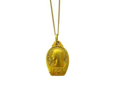 A gold pendant, designed as the portrait of a Madonna, presentation inscribed to the back and detailed 18 K, weight of pendan