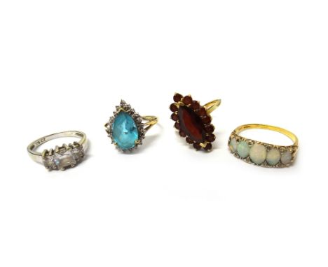 An 18ct gold and opal five stone ring, mounted with a row of five graduated oval opals, a 9ct gold and garnet set marquise sh