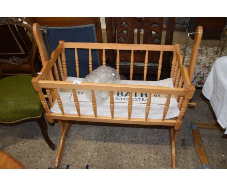 A swinging cot together with a sign saying "Hot Bath" and ceramic letters spelling out Bath