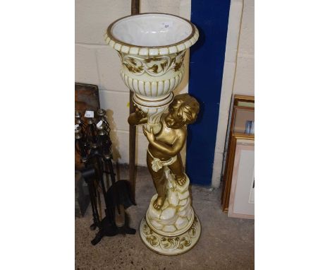 A 20th Century ceramic jardiniere stand formed as a putti holding a vase