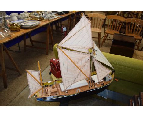 A model boat and a vintage tin plate Jones toy crane
