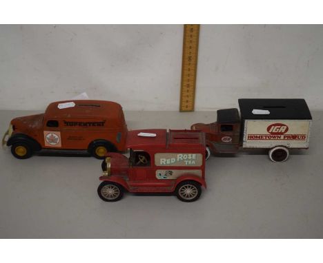 A money box modelled as a vintage car and two other money boxes