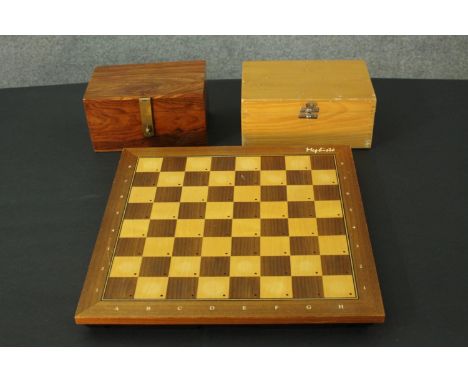 A 1980's Mephisto Exclusive hardwood modular electronic chess board along with two boxed chess sets. L.39 W.39cm. 