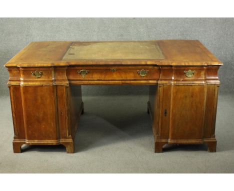 A Victorian walnut inverted breakfront partners desk, with a leather insert to the top, over nine drawers to one side, three 