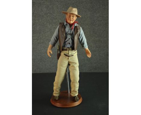 A Franklin Heirloom John Wayne doll and stand, porcelain and cloth, 1990. H.54cm. 