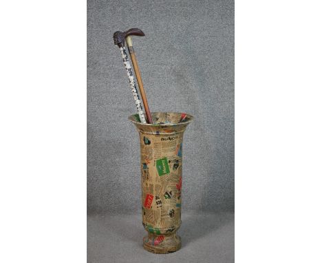 A contemporary newspaper papier-mâché design stick stand, an antler walking stick with silver collar and a turban shell mosai