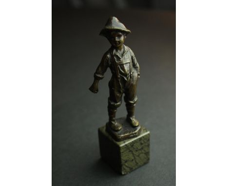A bronze figure of an Austrian boy mounted on a serpentine marble base. H.13cm. 