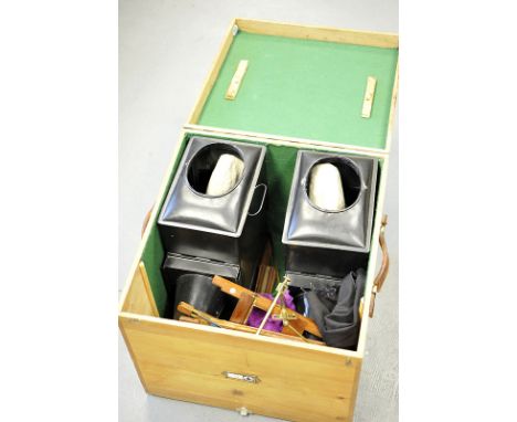 A Stereo Pair Of Magic Lanterns, together with various holders, disolves and accessories, in wooden box with fixing points to