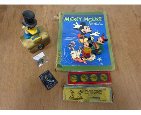 Walt Disney: small collection of early Micky Mouse memorabilia, including four 1930's/40's badges, toy projector slides, 1949