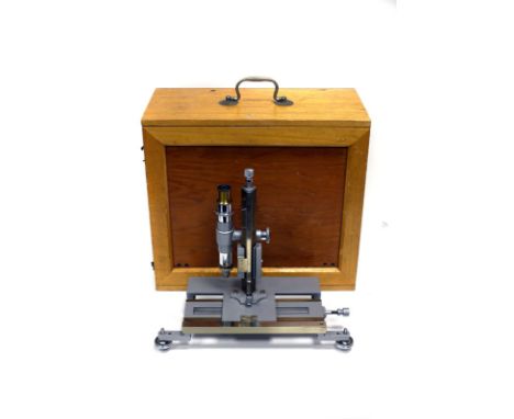 A Philip Harris Sliding Bench Compound Microscope, in maker's case