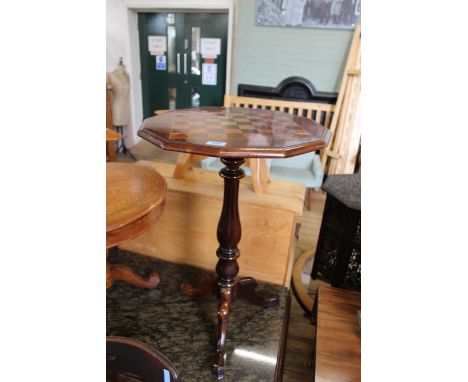 A rosewood tripod table with inlaid chequerboard top