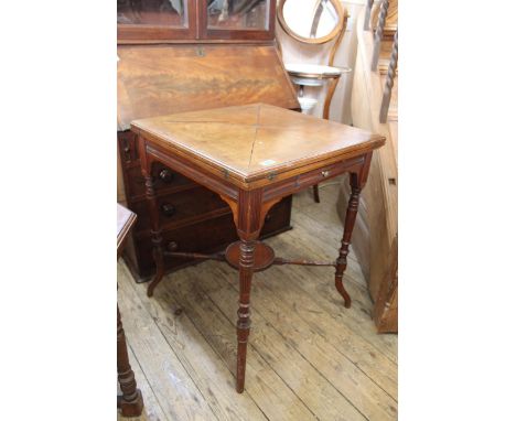 An Edwardian walnut envelope card table