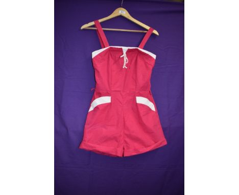 A 1950s Cerise and white cotton playsuit having pockets to front and button fastening to back.
