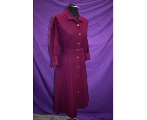 An aubergine wool late 1940s/early 1950s dress having brass button fastening to front and original belt, Lisscraft London lab