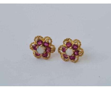 A pair of opal and ruby daisy head earrings 9ct