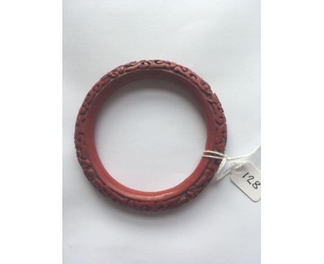 A carved Cinnabar bangle