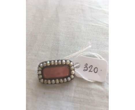 A antique gold mourning brooch with pearl border