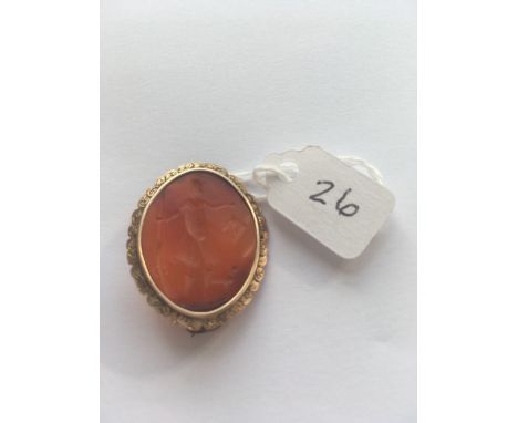 A GEORGIAN GOLD BROOCH SET WITH A CARNELIAN CARVED INTAGLIO DEPICTING A GEORGIAN MAN IN A HUNTING SCENE WITH DOG AND MUSKETT 