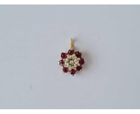A diamond and ruby cluster pendent 9ct