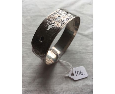 A wide silver buckle bangle