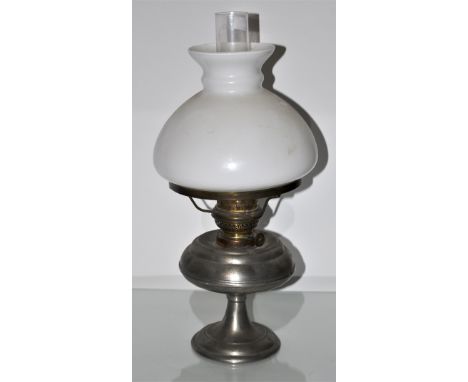 A metal and glass oil lamp