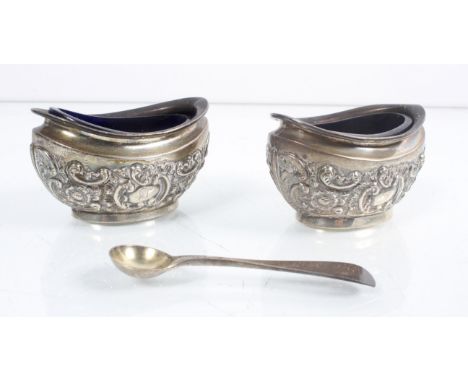 A pair of silver salts, possibly Chester, with blue glass liners and  salt spoon