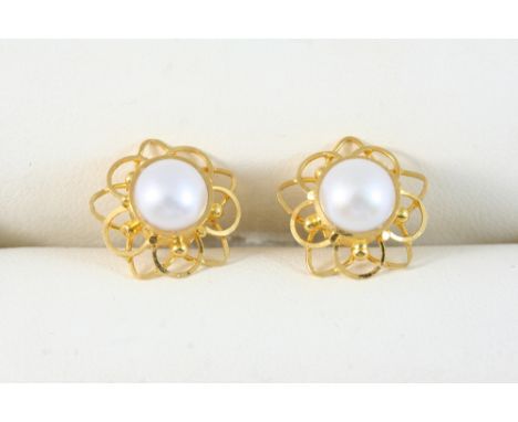A PAIR OF CULTURED PEARL AND GOLD STUD EARRINGS each set with a cultured pearl within an openwork gold mount.