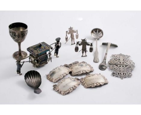 A MIXED LOT: A Chinese egg cup, a miniature sedan chair with bearers, two figural place card stands, a sifter spoon, a Danish