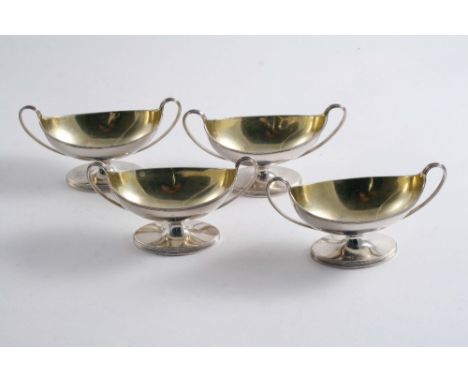 A SET OF FOUR GEORGE III BOAT-SHAPED SALTS  on oval pedestal bases with reeded borders & twin, loop handles, gilt interiors, 