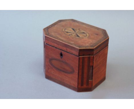 GEORGE III SATINWOOD TEA CADDY of chamfered rectangular form inlaid with mahogany stringing and a patera 6 1/4ins (16cms.) wi
