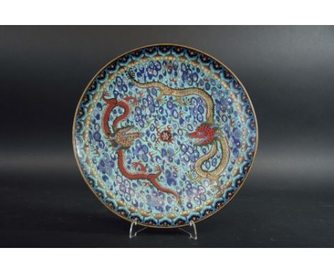 A CLOISONNE ENAMEL SAUCER DISH worked with two confronting dragons, pursuing a flaming pearl amongst clouds, the reverse with