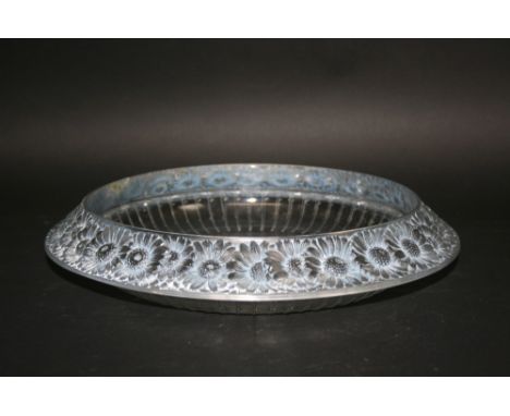 LALIQUE BOWL in the Marguerites design, with a border of flowers around the rim and a ridged back. Chip repair to rim. Signed