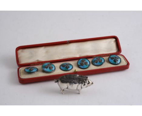 A SILVER PIG PIN CUSHION Birmingham 1918, 5.5 cms and a set of six plated & enamel buttons of shamrock design, c.1900 (cased)