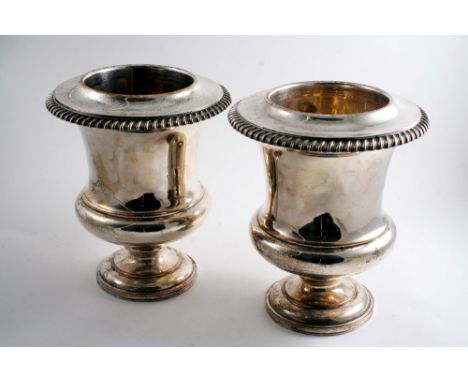 A PAIR OF OLD SHEFFIELD PLATED WINE COOLERS of campana form on pedestal bases with gadrooned collars & drop-in liners, 1810-2