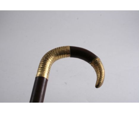 A WALKING STICK with gilt metal decorated handle;  83 cms