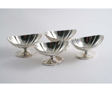 A SET OF FOUR GEORGE III PEDESTAL SALTS of shaped oval outline with reeded rims, by Joseph Scammel, London 1791;  4.25"  (10.
