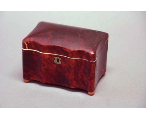 A TORTOISESHELL TEA CADDY of serpentine form, with ivory trimmings, the interior with two lidded divisions, 5 1/2ins. (14cms.