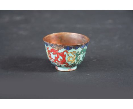 AN EARLY CLOISONNE ENAMEL CUP possibly 15th 16th century, worked with scrolls,  2 ins. (5cms.) dia