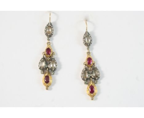 A PAIR OF GEORGIAN RUBY AND DIAMOND DROP EARRINGS each set with three oval-shaped rubies and three rose-cut diamonds, in silv