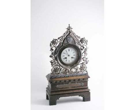 A VICTORIAN PLATED-MOUNTED OAK "GOTHIC" MANTEL CLOCK with a white enamelled dial, the openwork front centred at the to with a