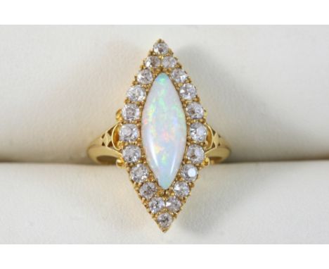 AN OPAL AND DIAMOND MARQUISE-SHAPED CLUSTER RING the marquise-shaped white opal is set within a surround of circular-cut diam