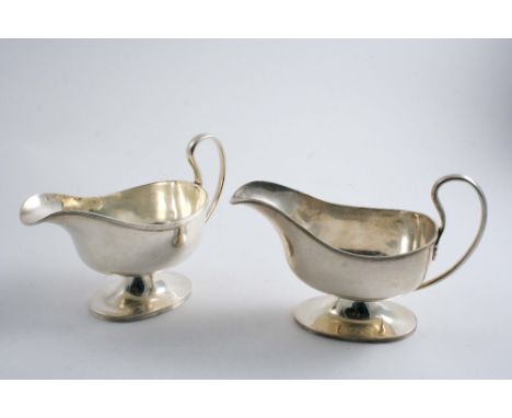A PAIR OF MODERN SAUCE BOATS with reeded borders, loop handles & oval pedestal bases, by William Hutton & Sons Ltd., Sheffiel