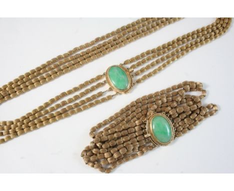A GOLD FOUR ROW CHAIN NECKLACE formed with oval-shaped engraved links set to an oval jade and gold clasp, 46cm. long, 51 gram