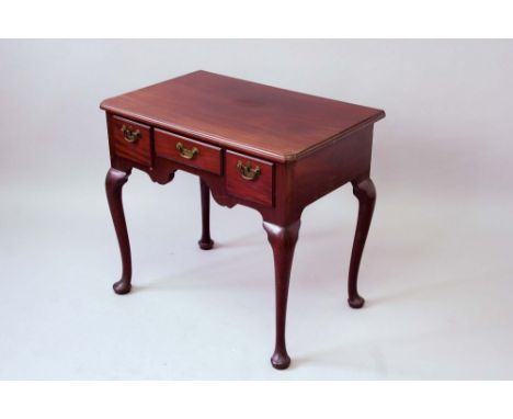 A GEORGE III MAHOGANY LOWBOY the top with a moulded edge and slightly chamfered front corners, the shaped frieze fitted with 