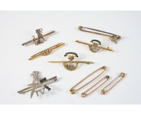 A GOLD AND ENAMEL REGIMENTAL BROOCH FOR THE SOMERSET LIGHT INFANTRY 5.5cm. long, together with a similar smaller brooch, 5cm.