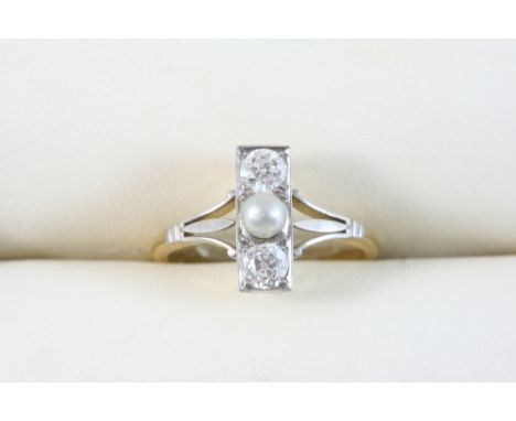 A DIAMOND AND PEARL RING centred with an untested pearl with two old brilliant-cut diamonds, in 18ct. gold and platinum. Size