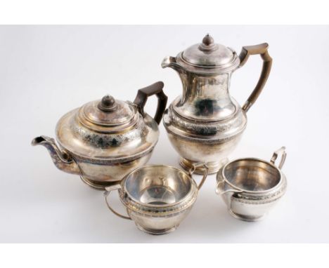 A MODERN FOUR-PIECE TEA SERVICE  comprising tea pot, hot water jug, cream jug & sugar bowl with circular bodies & decorative 