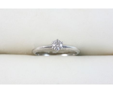 A DIAMOND SOLITAIRE RING BY TIFFANY & CO. set with a round brilliant-cut diamond weighing 0.21 carats, in platinum, together 